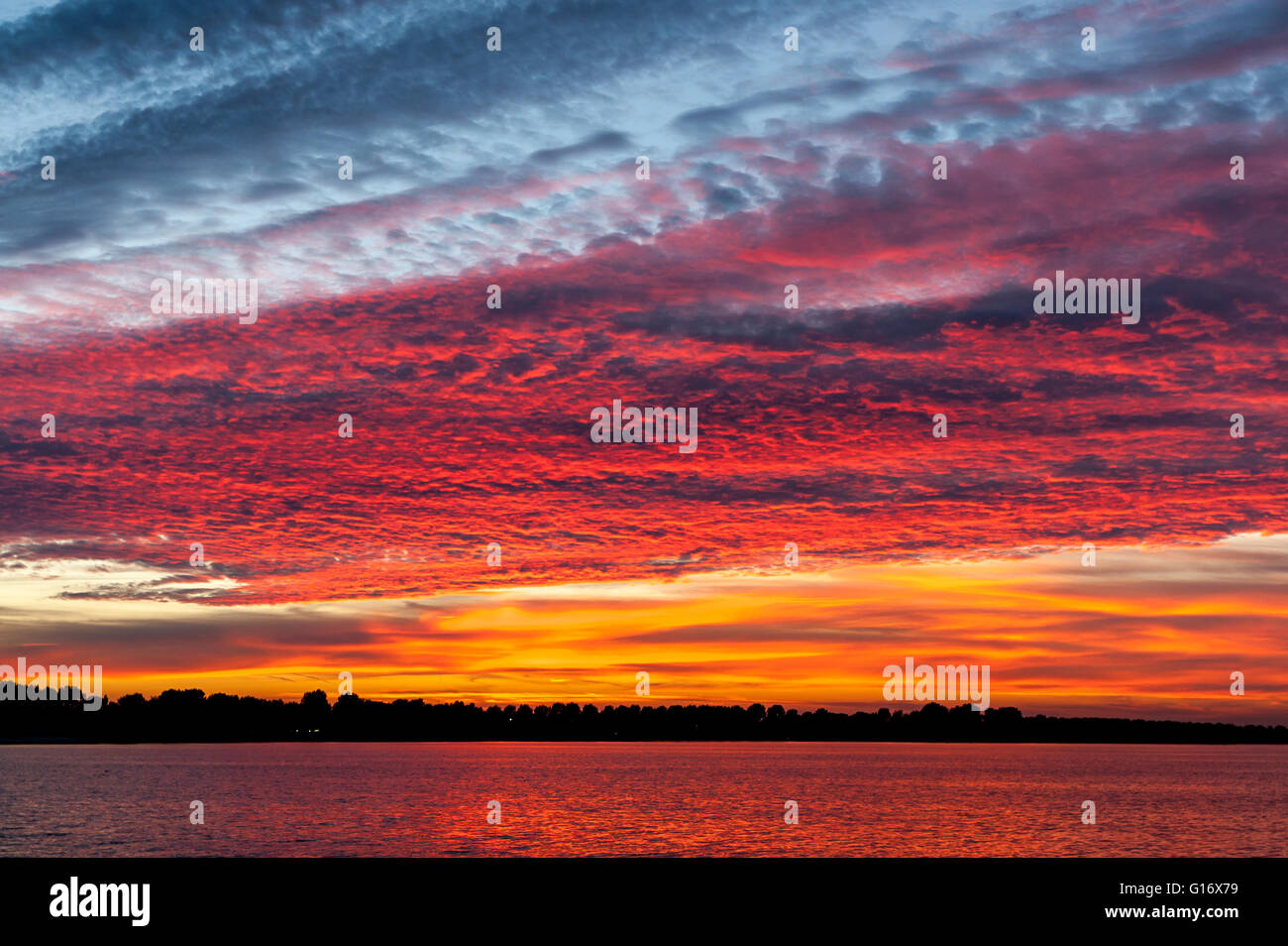 Colourful cloudscape of altocumulus clouds at sunset, IJsselmeer, Netherlands Stock Photo