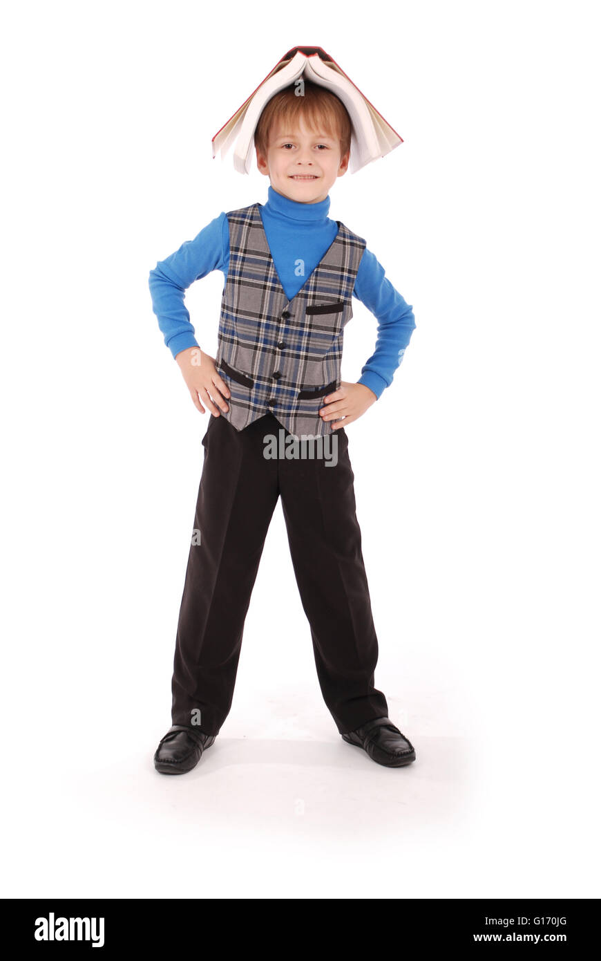 Boy holding a book over his head isolated on white Stock Photo