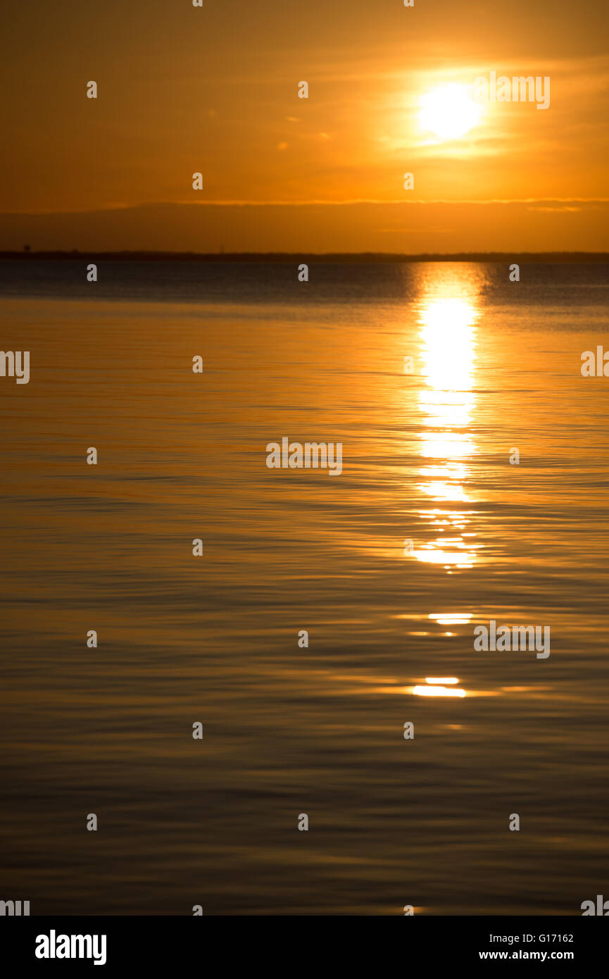 Sun rays reflectinf off a body of water. Stock Photo