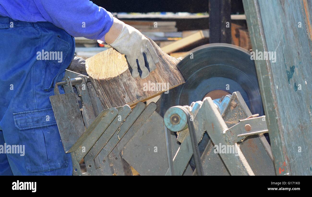 Man cutting the log on circular saw in garden. Cutting wood, Cutting