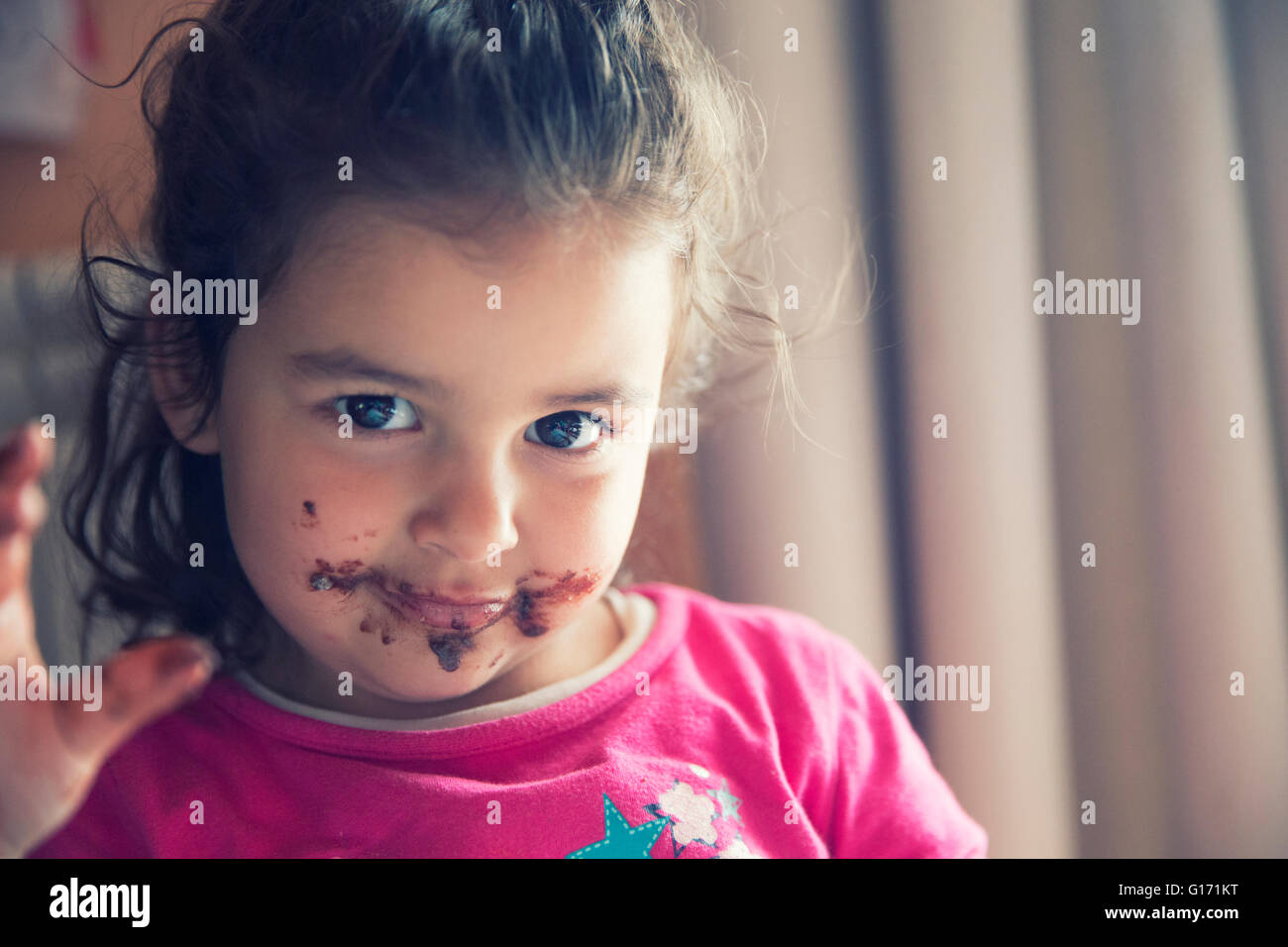 Girl with dirty mouth eating chocolate cookie Stock Photo Alamy