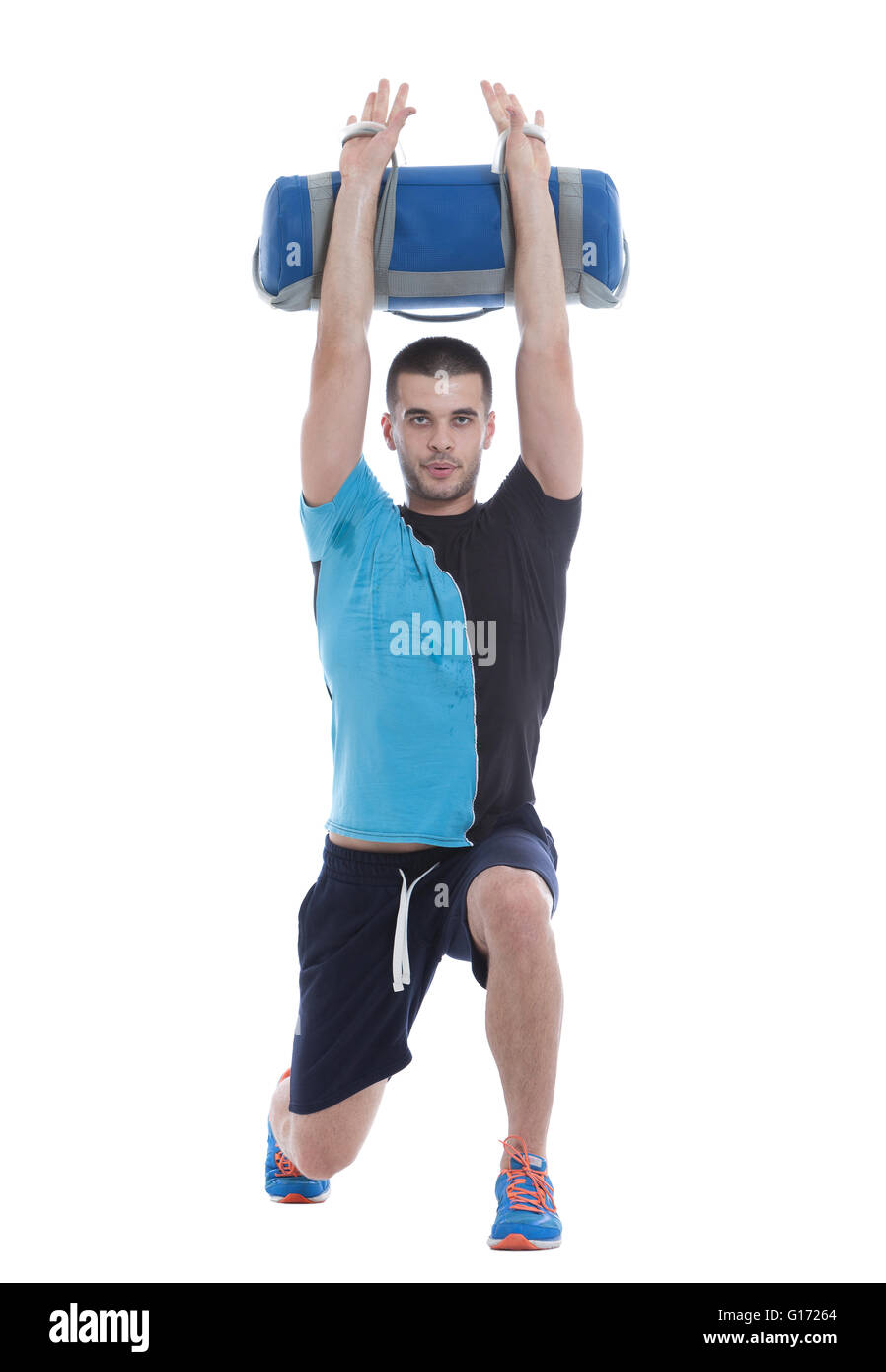 Fitness trainer doing a demonstration of core bag exercise. Image isolated on white background. Stock Photo