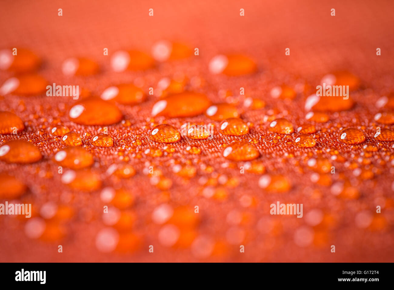Drops of water on red waterproof cloth Stock Photo