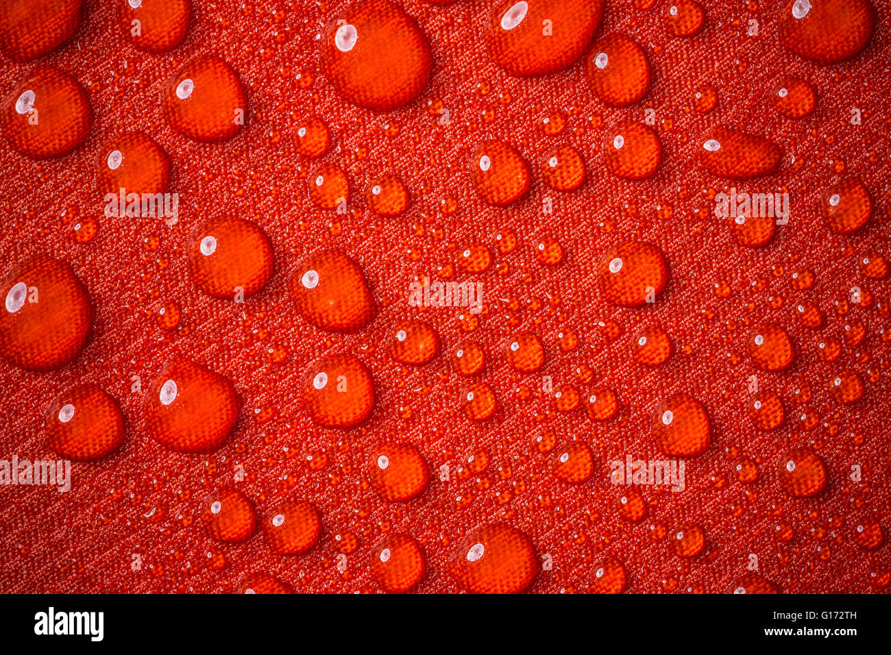 Drops of water on red waterproof fabric Stock Photo