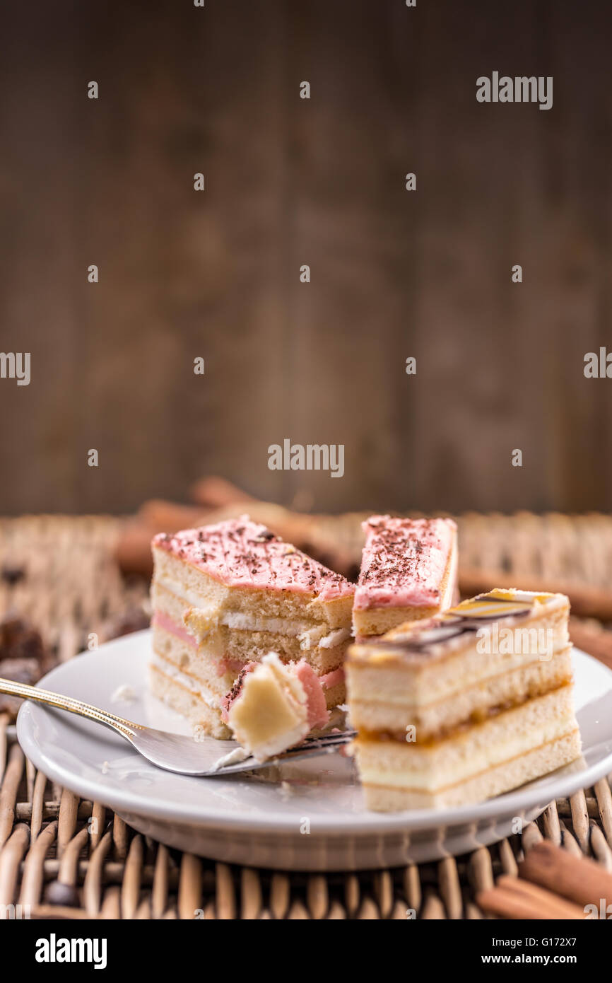 Delicious layered mini cakes on white plate Stock Photo