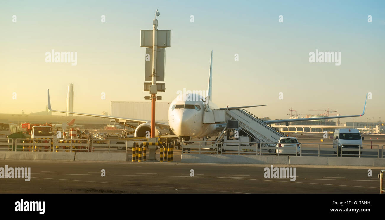 Passenger plane in airport at sunny morning Stock Photo