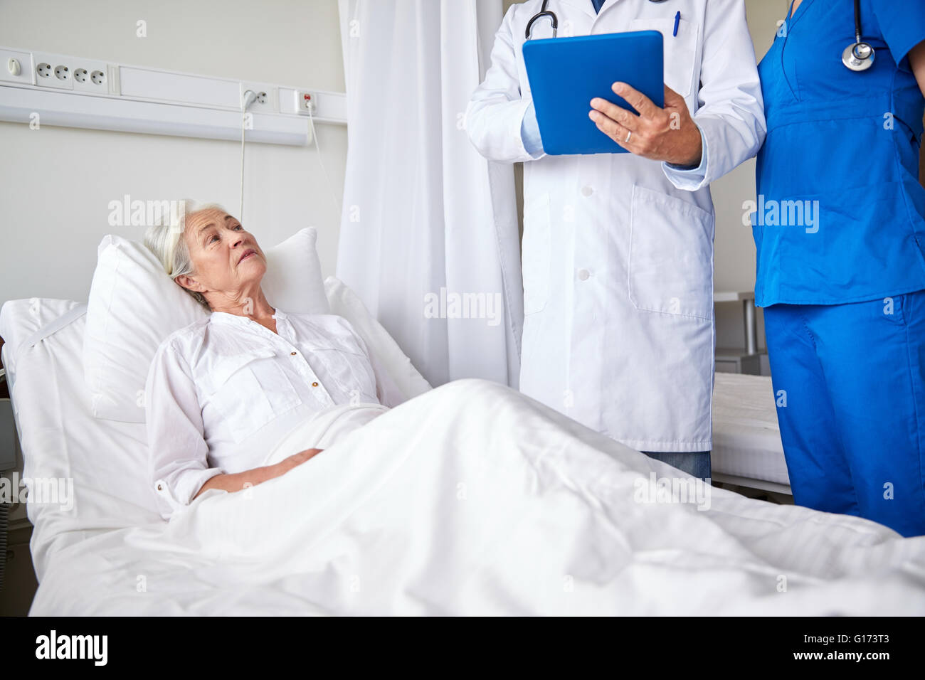 doctor and nurse visiting senior woman at hospital Stock Photo - Alamy
