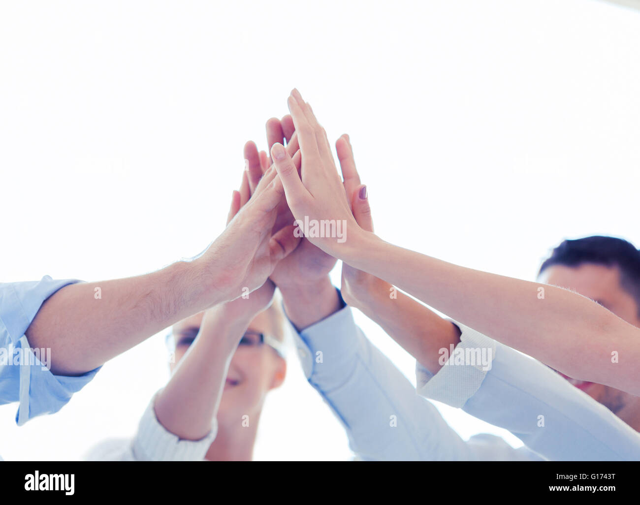 happy business team giving high five in office Stock Photo - Alamy