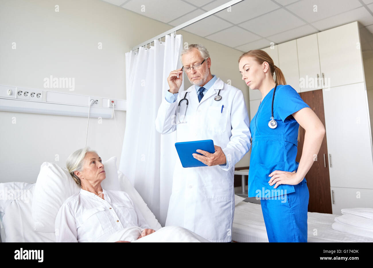 doctor and nurse visiting senior woman at hospital Stock Photo - Alamy