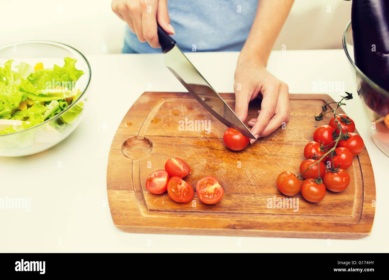 close up of woman chopping tomatoes with knife Stock Photo - Alamy