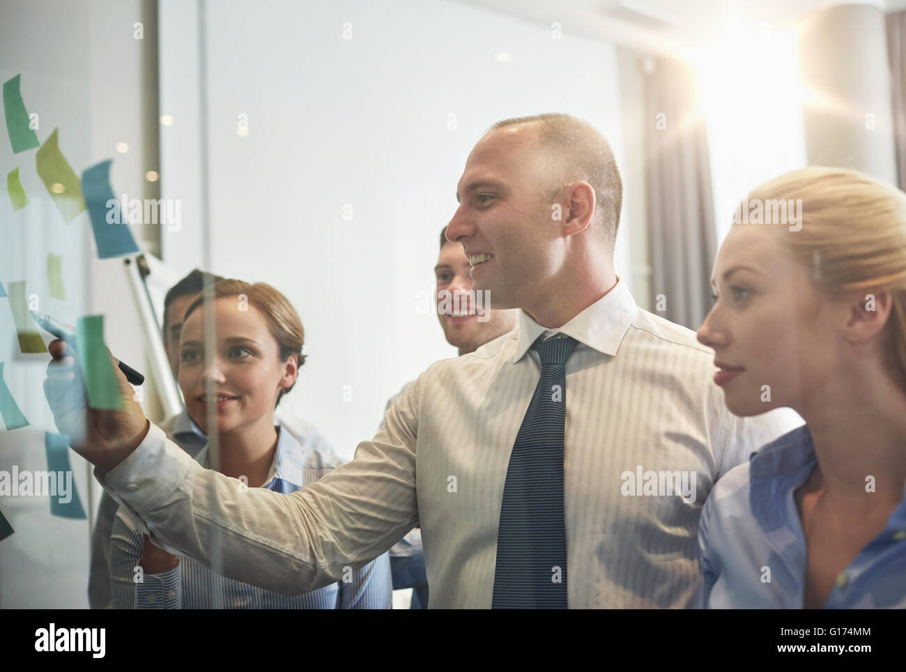 smiling business people with marker and stickers Stock Photo - Alamy