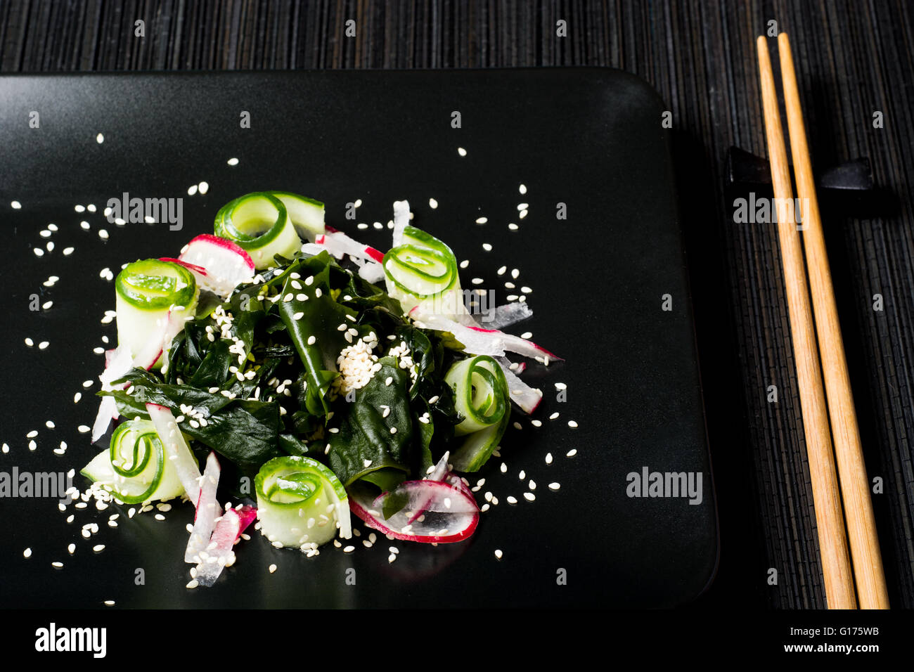 Fresh healthy vegetarian salad with wakame seaweed, cucumber and radish Stock Photo