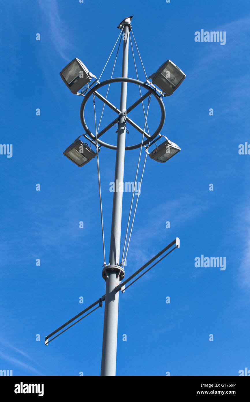 Streetlamp over blue sky with bird on a top Stock Photo