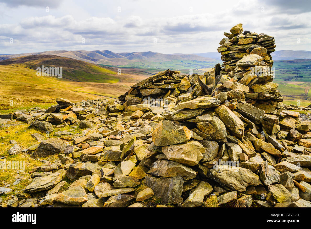 Summit cairn on Whinfell Beacon, looking towards Grayrigg Common and the Howgill Fells in the  eastern Lake District Stock Photo