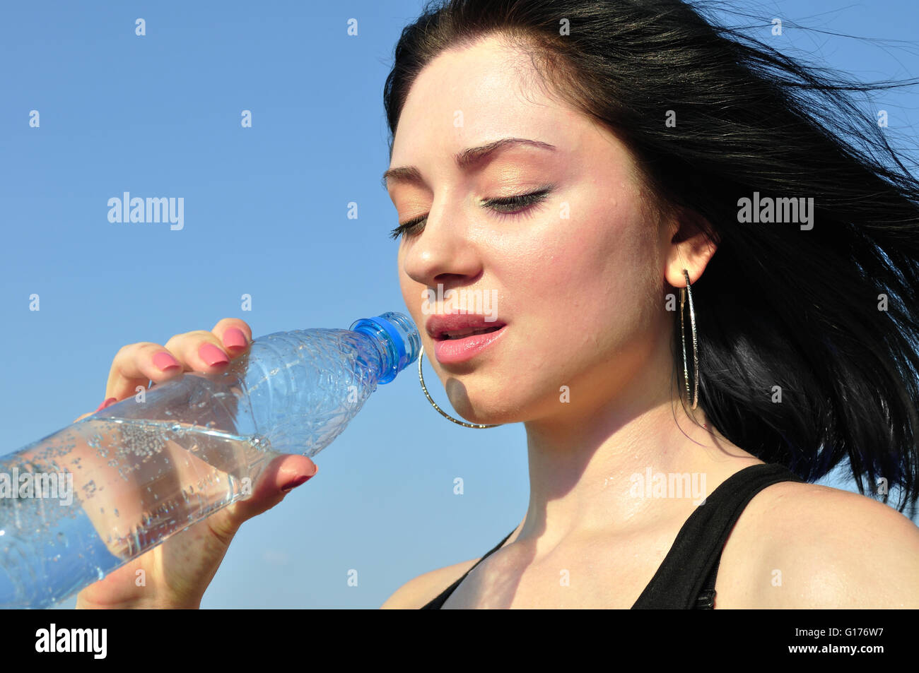 thirsty young woman drinking cold water Stock Photo