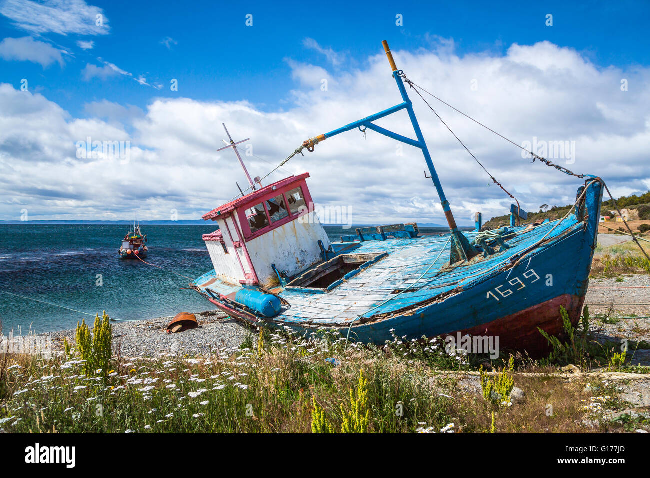 An old fishing boat on the shores of the Strait of Magellan at Punta Carrera near Punta Arenas, Chile, South America. Stock Photo