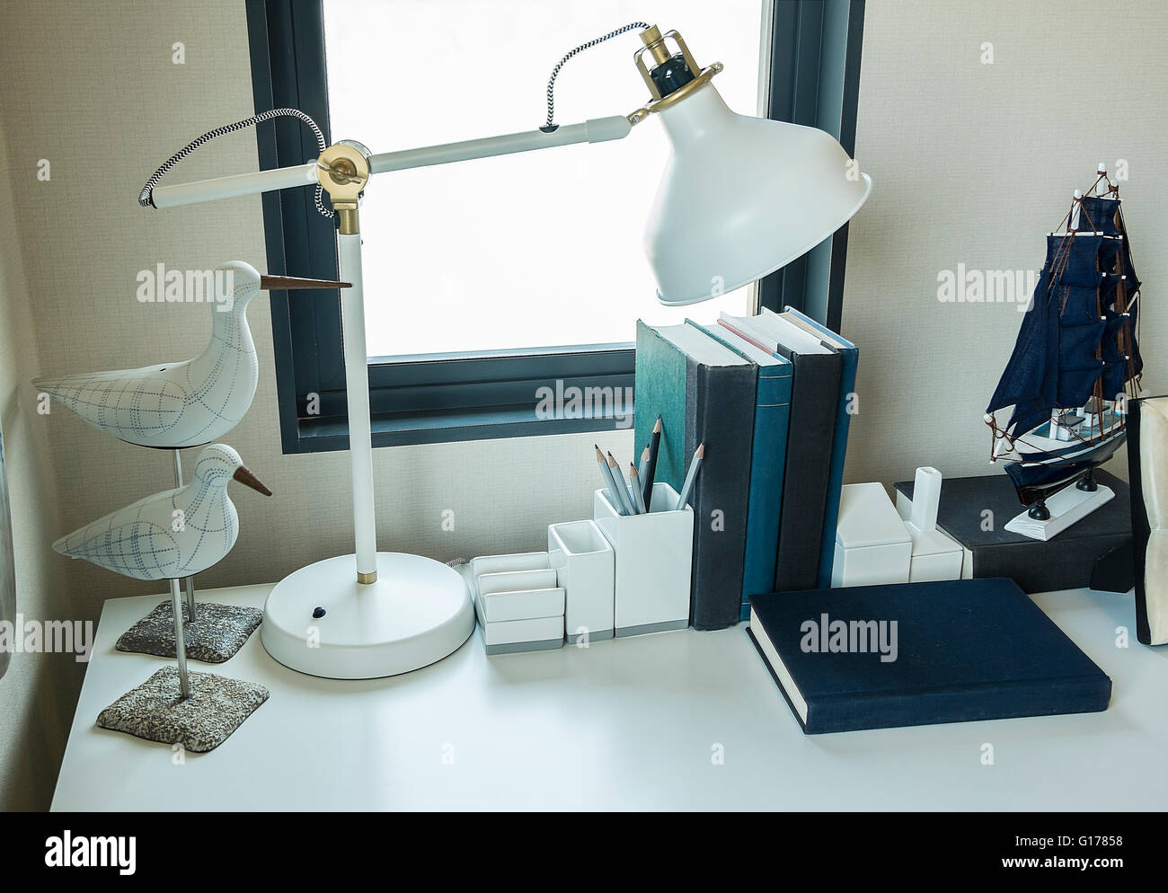 work table with lamp,pencil, books in a home Stock Photo - Alamy