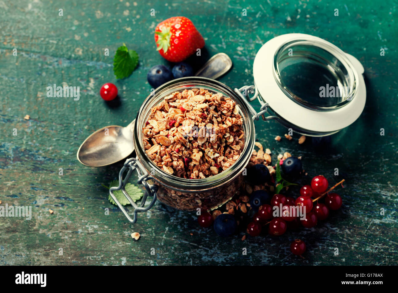 Healthy breakfast of muesli, berries with yogurt and seeds on dark background -  Healthy food, Diet, Detox, Clean Eating or Vege Stock Photo