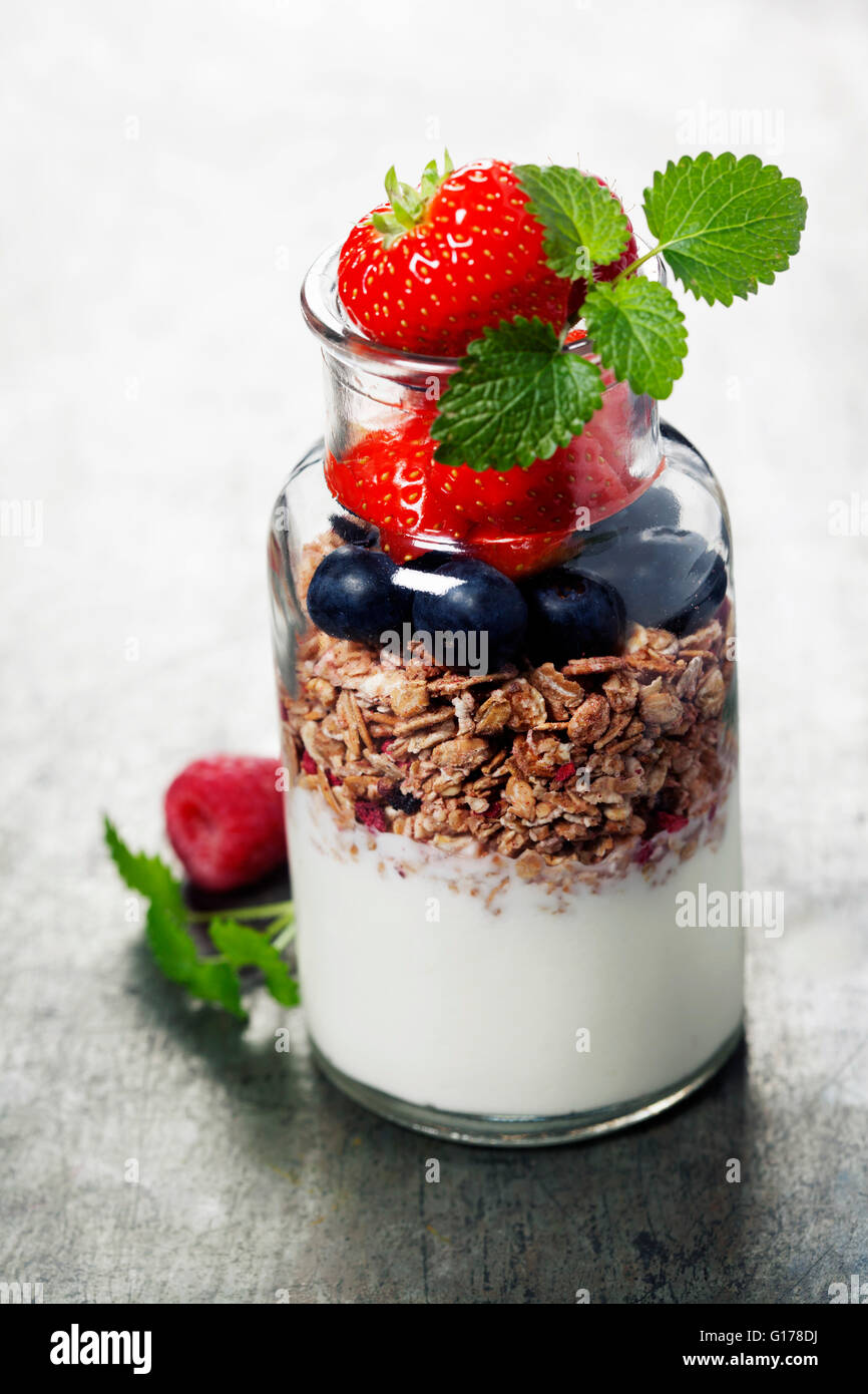 Yogurt with baked granola and berries - Healthy Breakfast concept Stock Photo