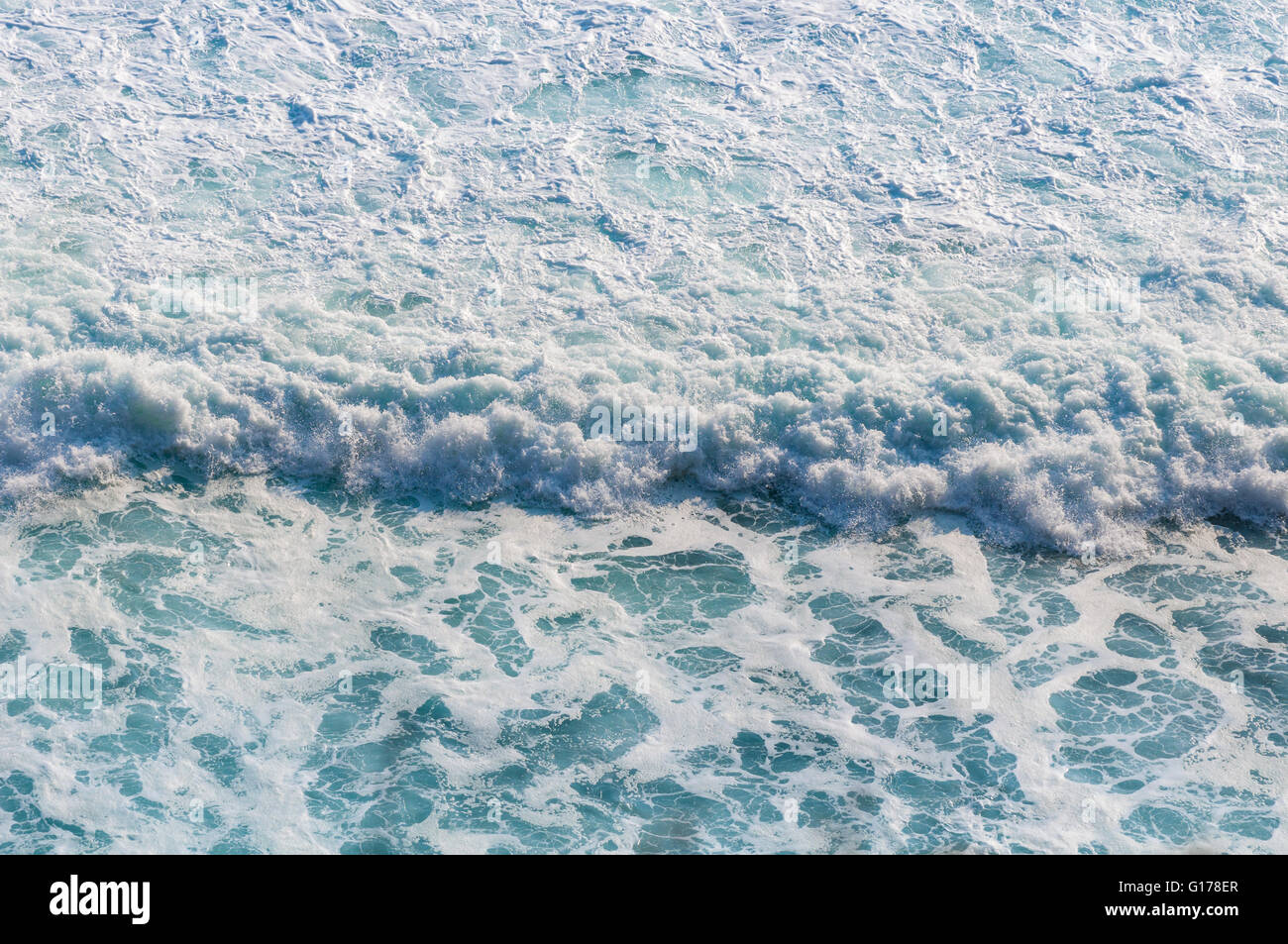 Blue sea with waves and foam Stock Photo - Alamy