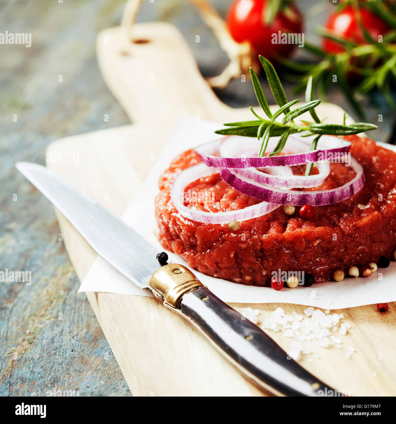Raw Ground beef meat Burger steak cutlet with seasoning on vintage wooden boards Stock Photo