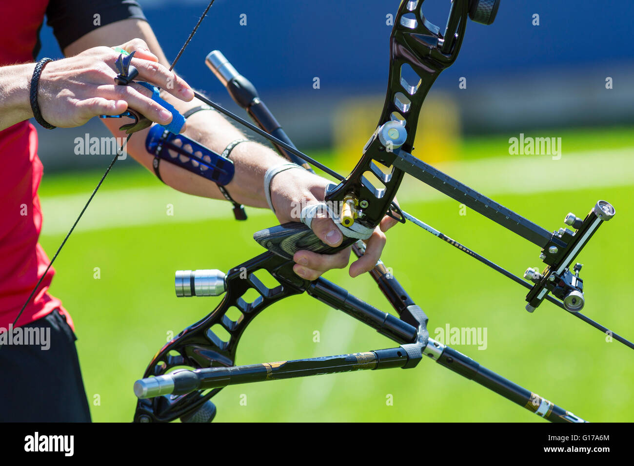 A man is shooting with a recurve bow during un open archery competition