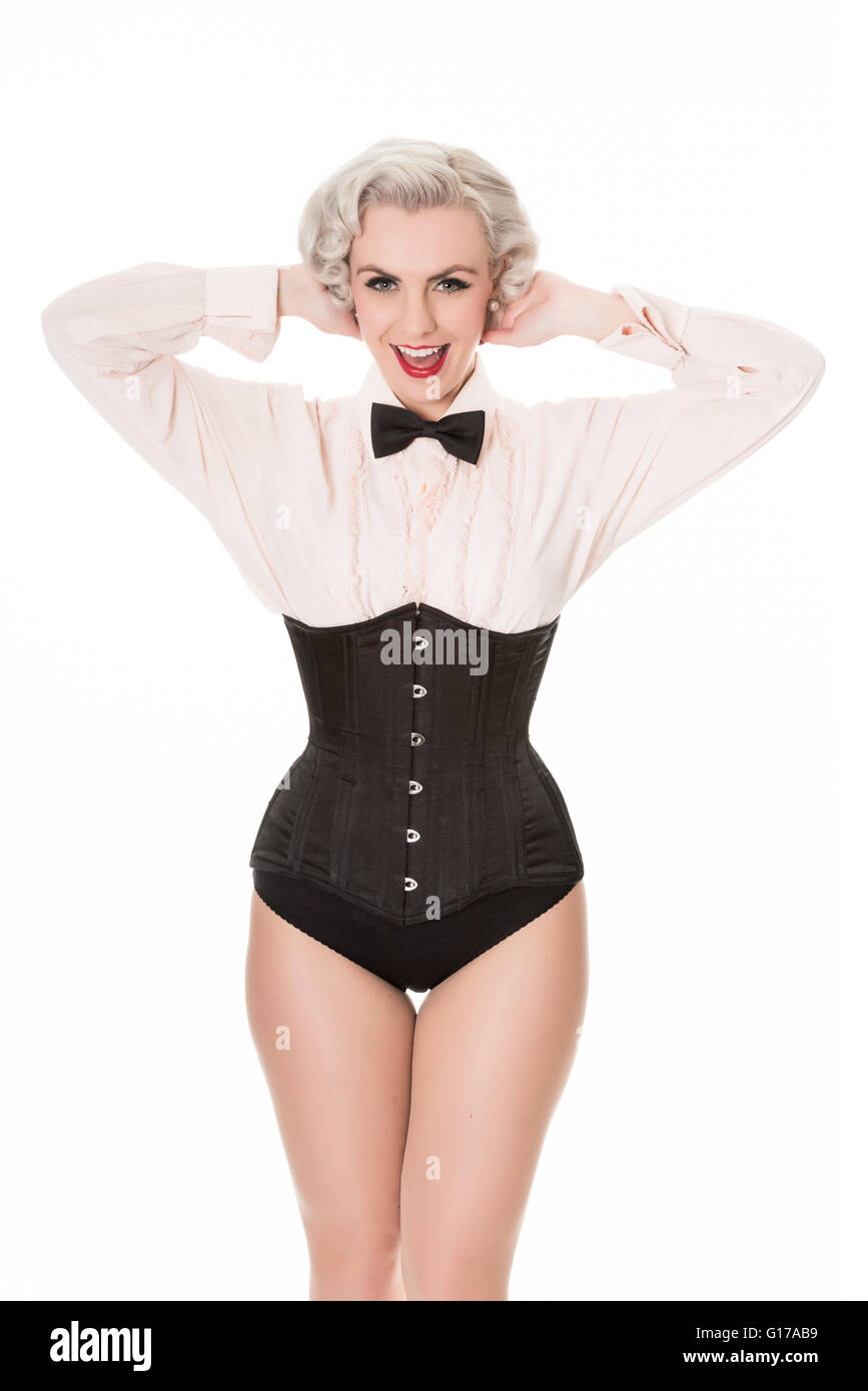 Happy retro girl with bow tie & corset, isolated on white Stock Photo