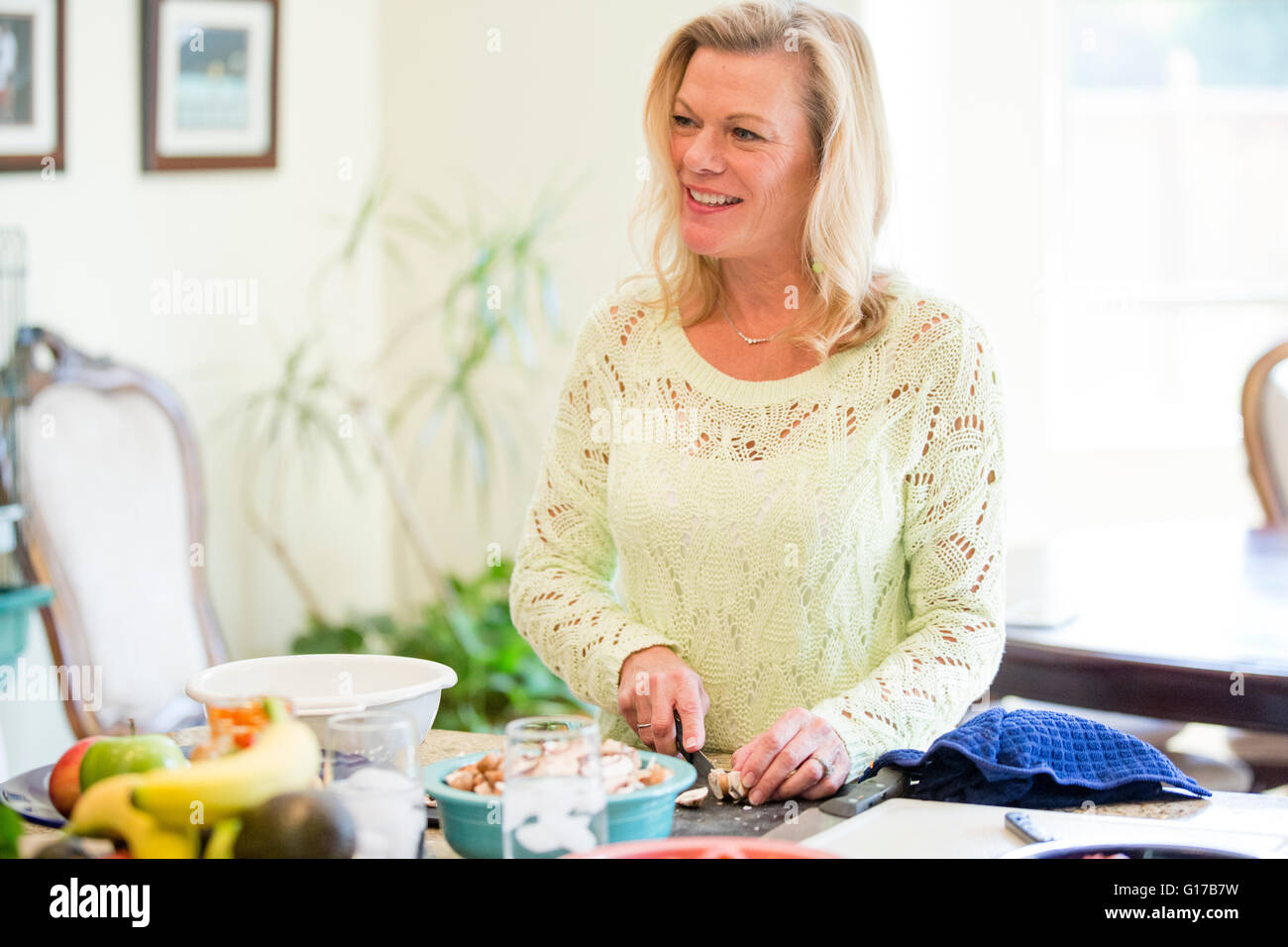 Woman preparing meal in kitchen Stock Photo Alamy