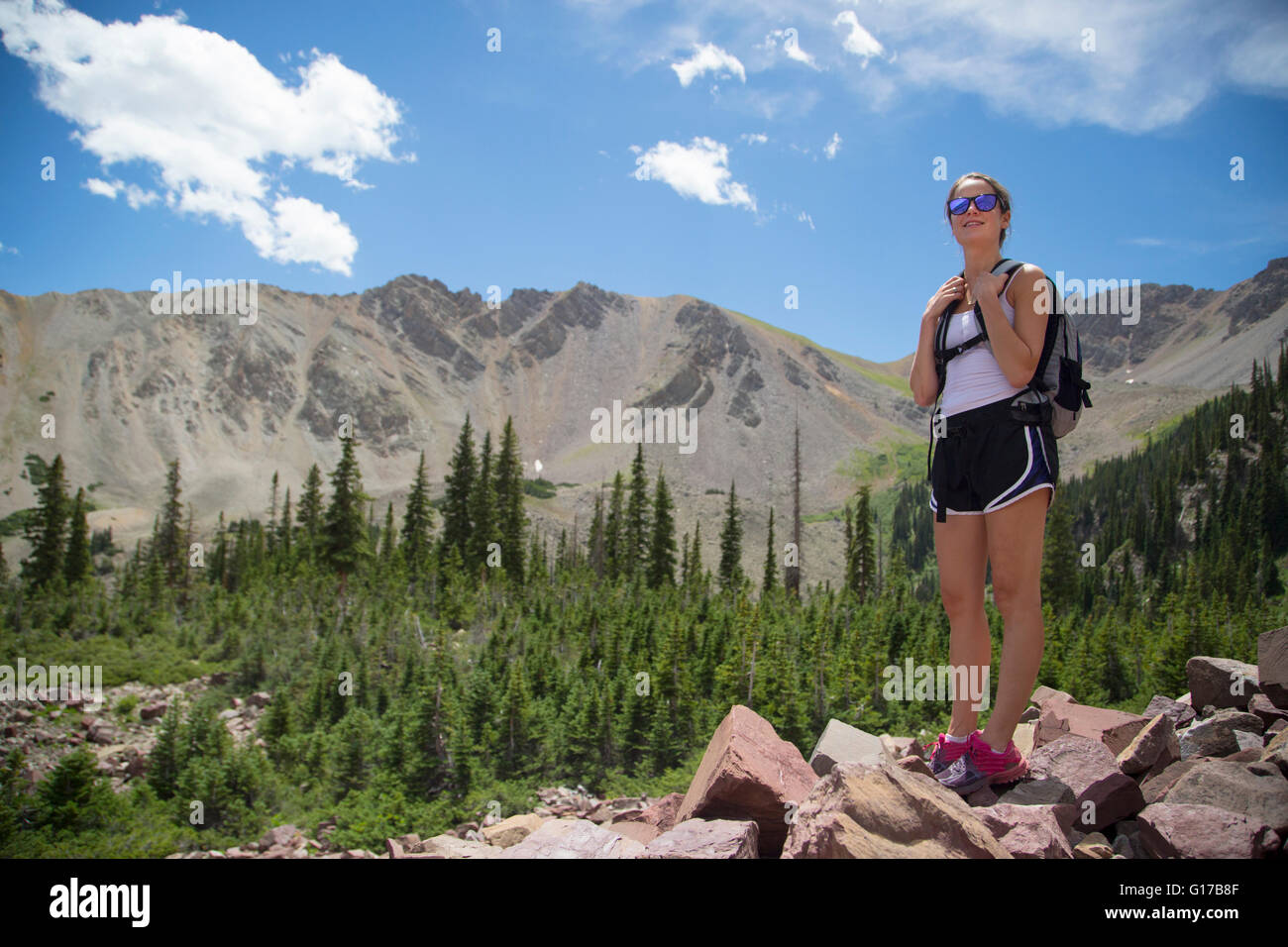Hiker enjoying view on rocks, Aspen, Colorado Stock Photo