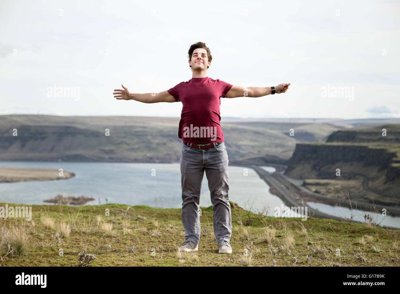 Man standing on mountain top, breathing fresh air, Colombia River Gorge, Washington, USA Stock Photo