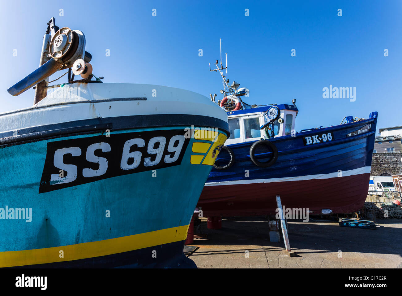 Fishing Boats out of the Water at Seahouses Harbour Undergoing Seasonal Maintenance Stock Photo