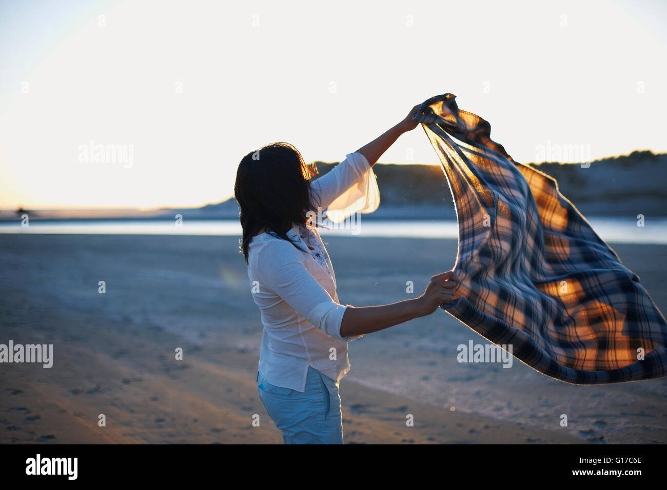 Woman sunset beach carefree hi-res stock photography and images - Alamy