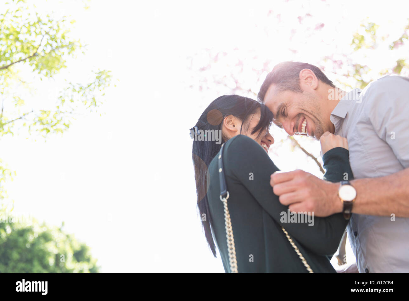 Low angle view of couple face to face smiling Stock Photo