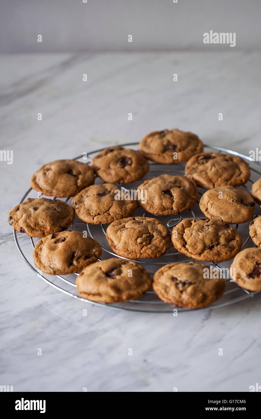 Peanut butter and chocolate cookies on a cooling rack and white marble table Stock Photo