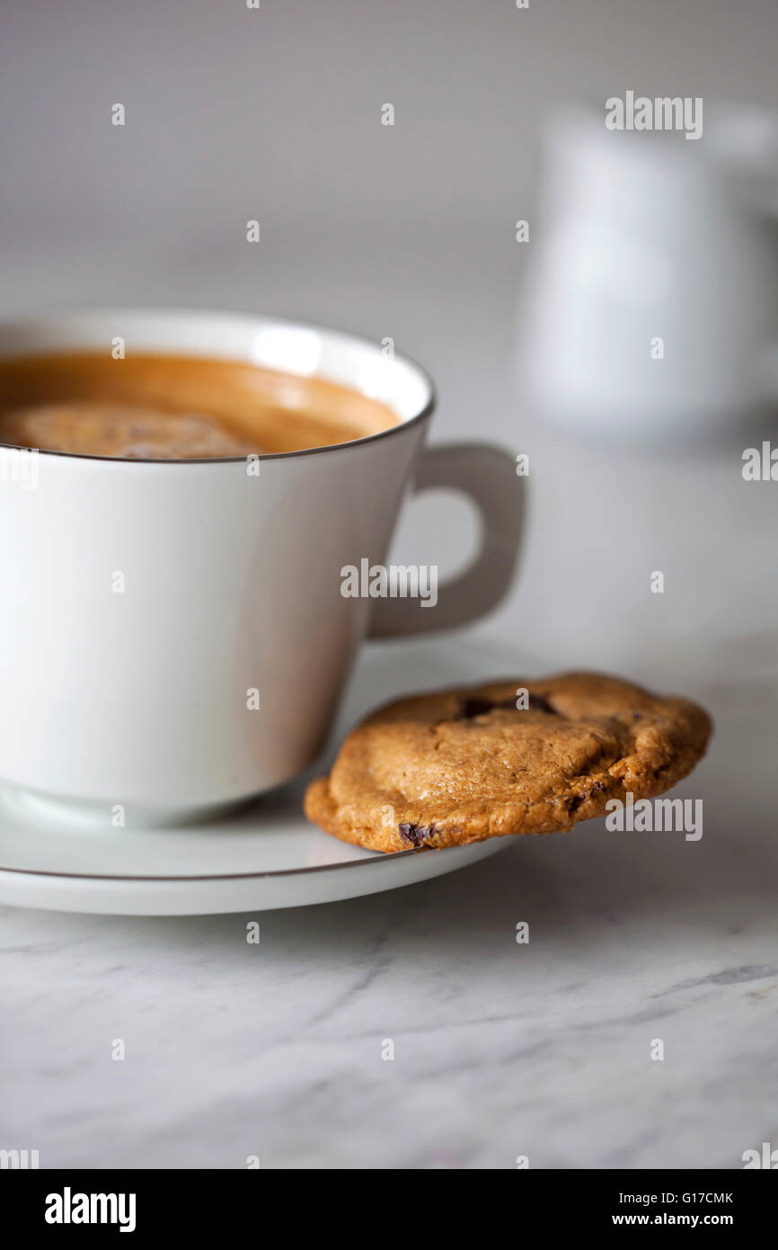 Peanut butter and chocolate cookie and a cup of coffee on a white marble table Stock Photo