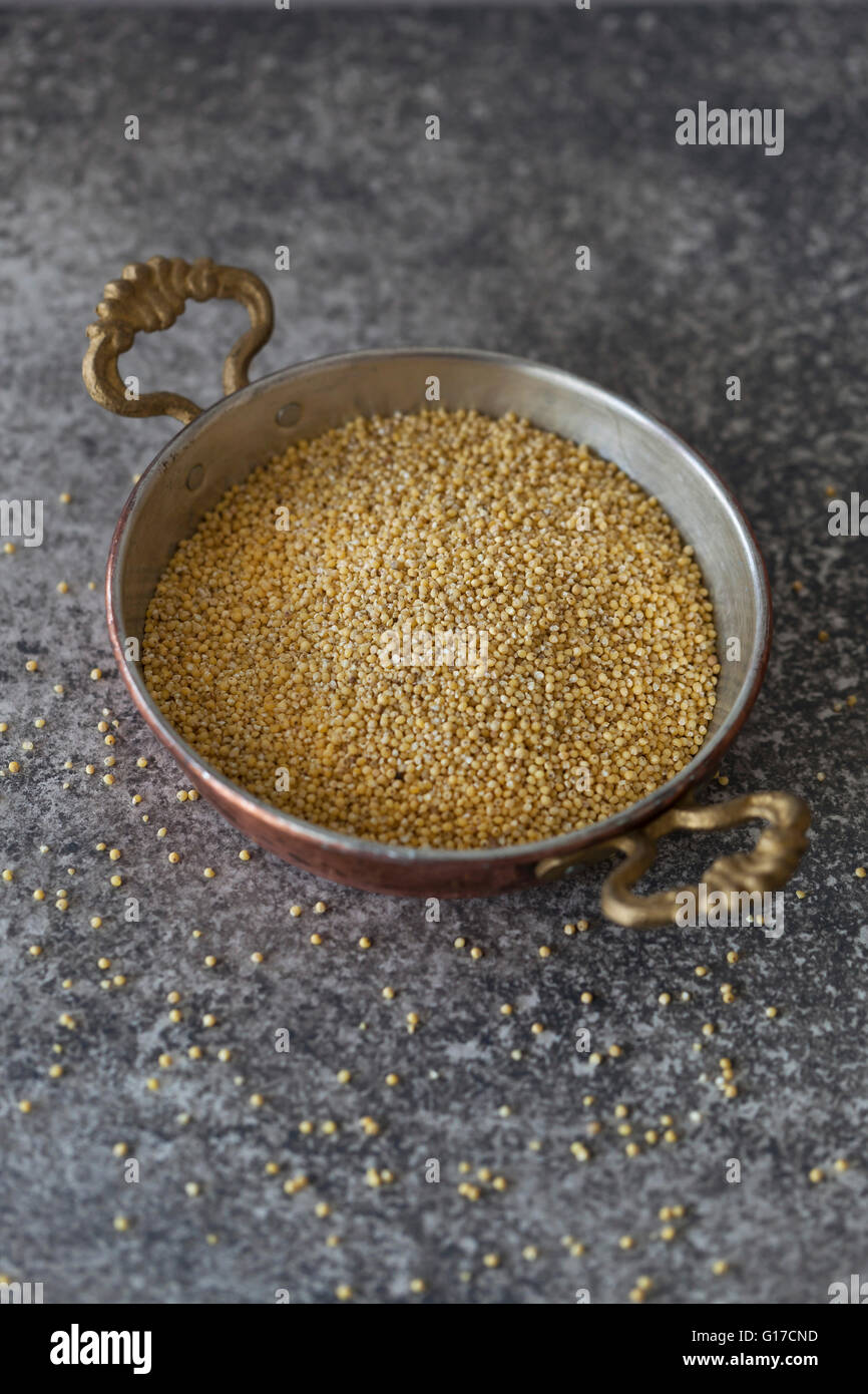 Uncooked pearl millet in a bowl on a grey background Stock Photo Alamy