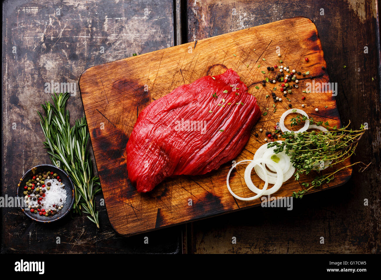 Raw fresh meat filet and condiments on dark background Stock Photo
