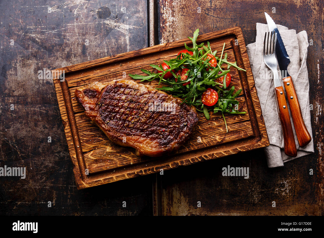 Grilled beef barbecue Striploin steak and salad with tomatoes and