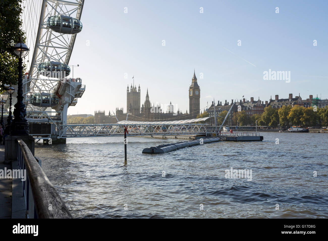 Festival Pier with London Eye and the Houses of Parliament on the Thames riverbanks in London at daylight Stock Photo