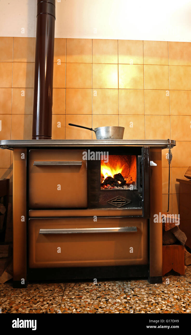 old woodburning stove in the kitchen of mountain home Stock Photo Alamy