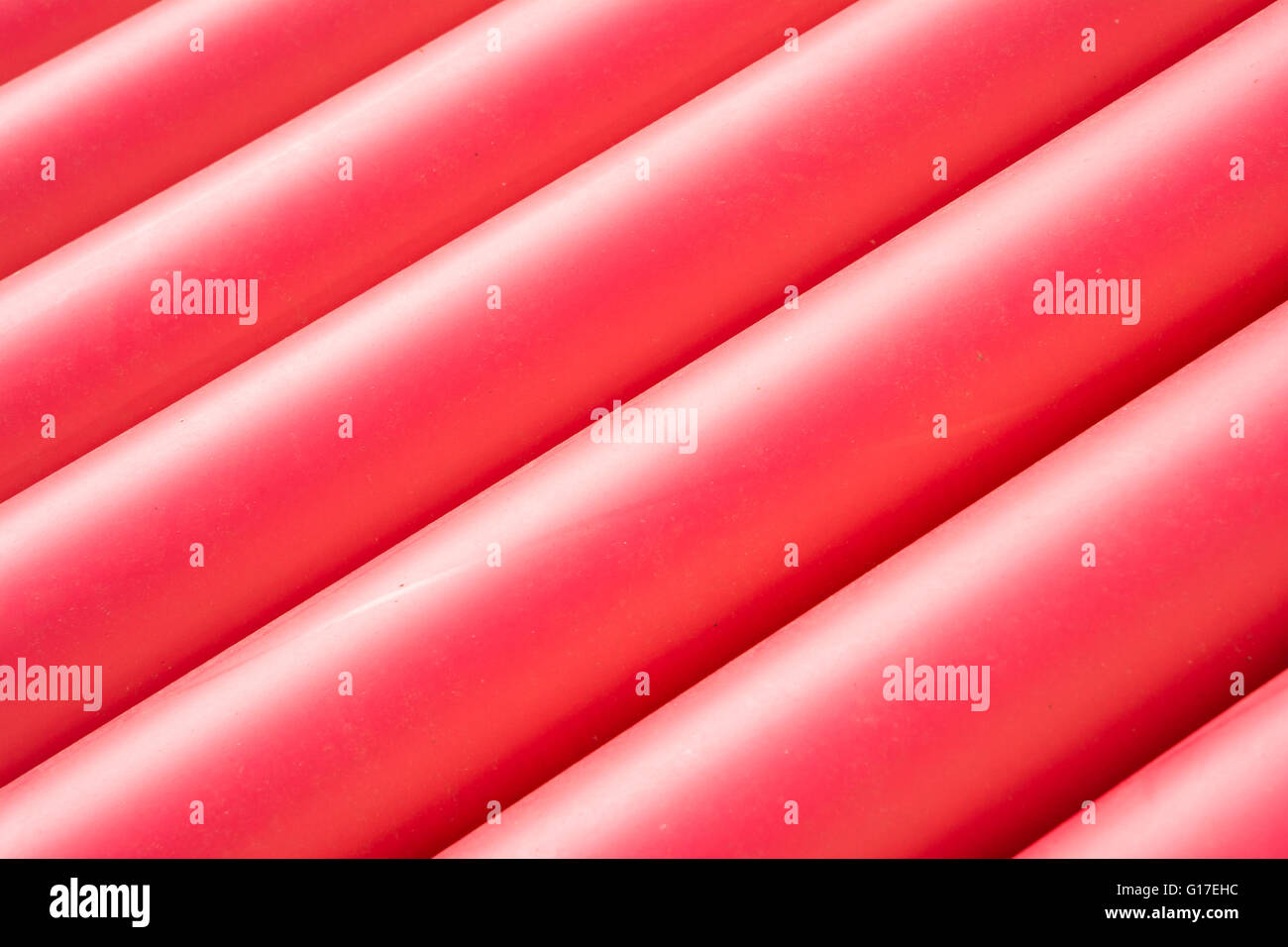 Pile of red pvc protective pipes Stock Photo Alamy