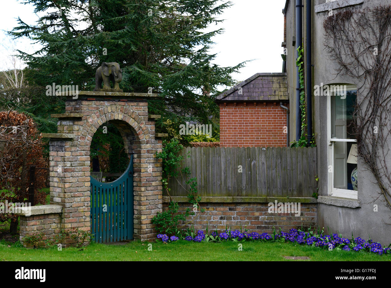 National Botanic Gardens Glasnevin Dublin red brick wall arch house spring primrose bedding display RM Floral Stock Photo