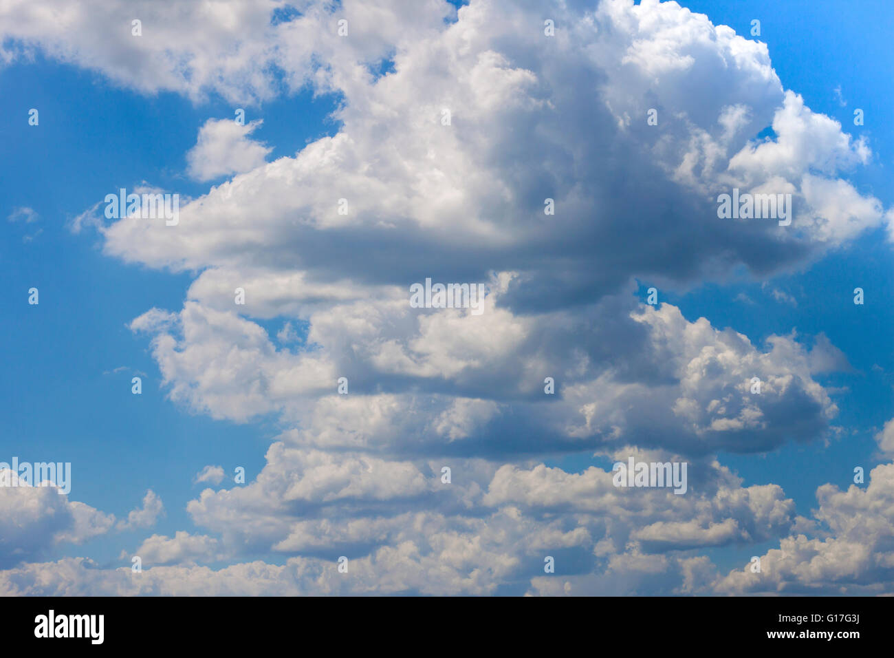 Blue sky with puffy white clouds Stock Photo - Alamy