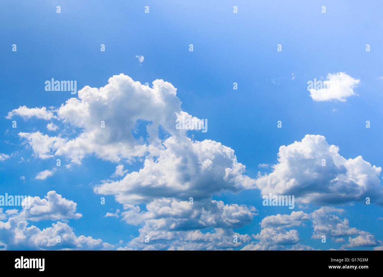 Blue sky with puffy white clouds in bright sunny day Stock Photo - Alamy
