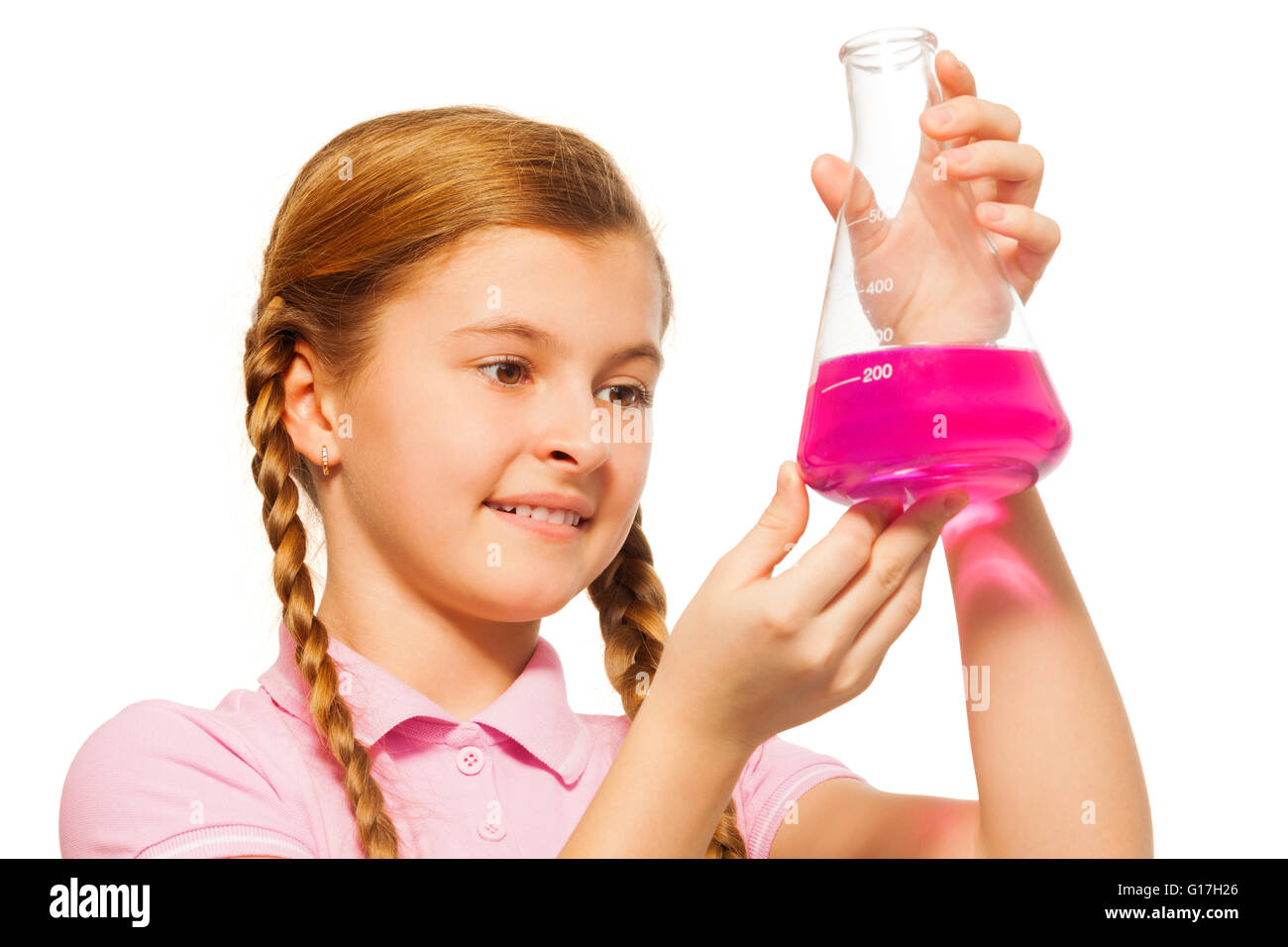 Young chemist pouring pink reagent in glass retort Stock Photo