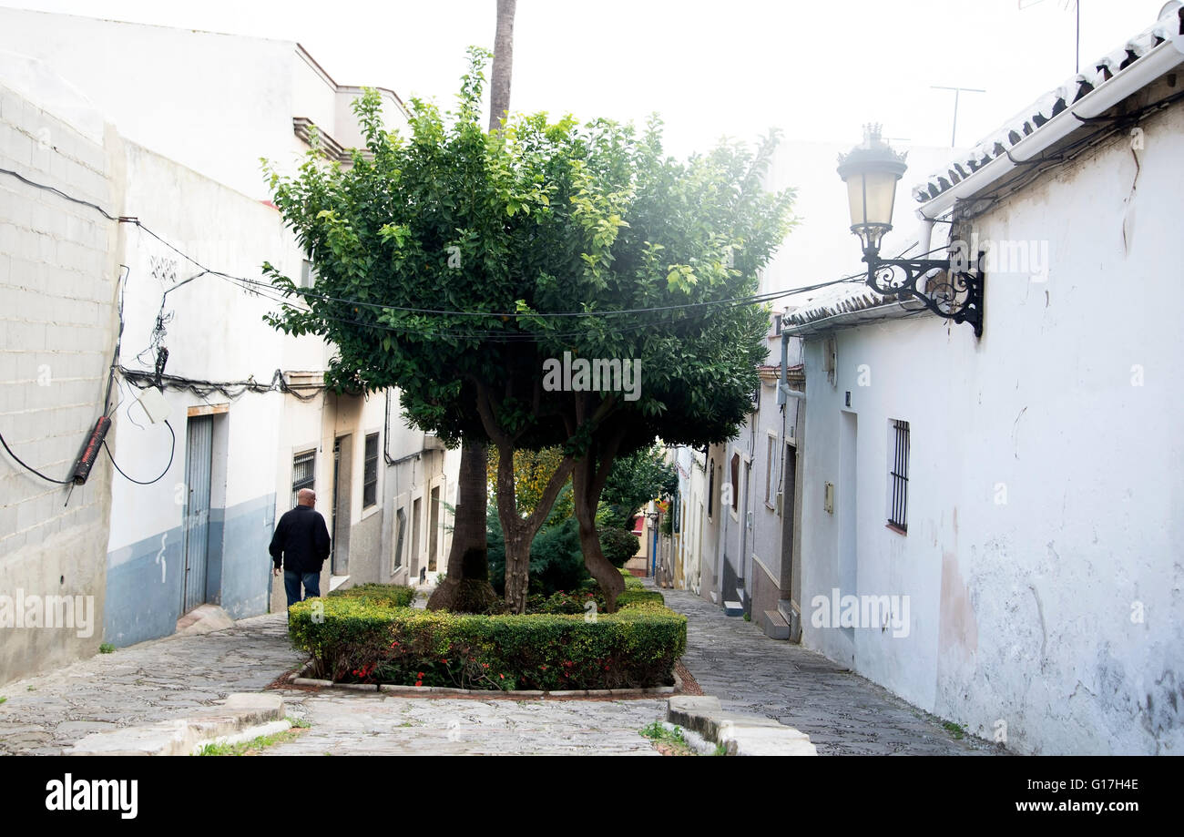 man walks down cobbled side street  in Algeciras, Southern Spain Stock Photo
