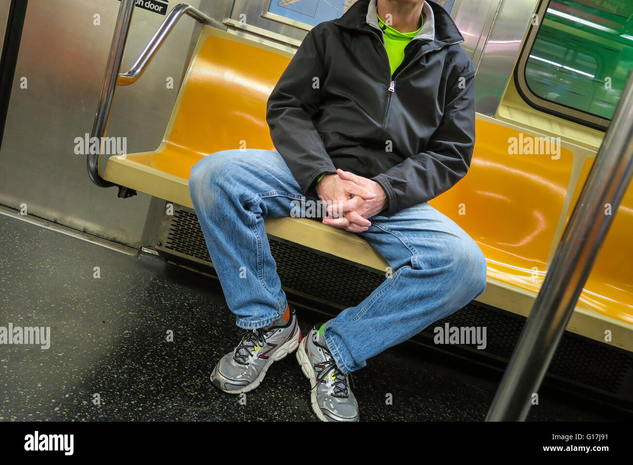 Man Hogging More than One Seat (man spreading) on New York City Subway (tube), NYC, USA Stock Photo