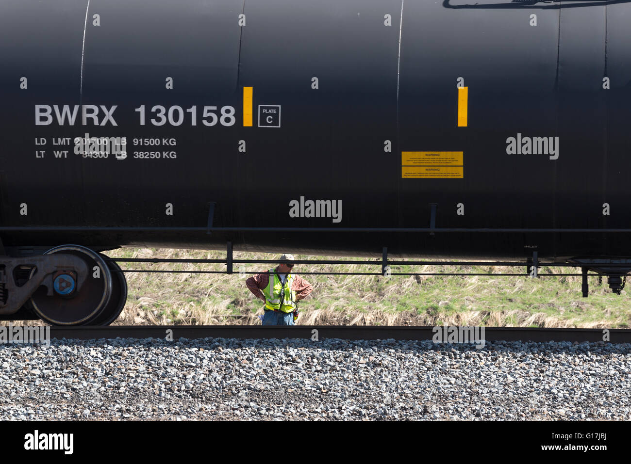 Railroad worker watching oil tank cars in Utah's Salt Lake Valley. Stock Photo
