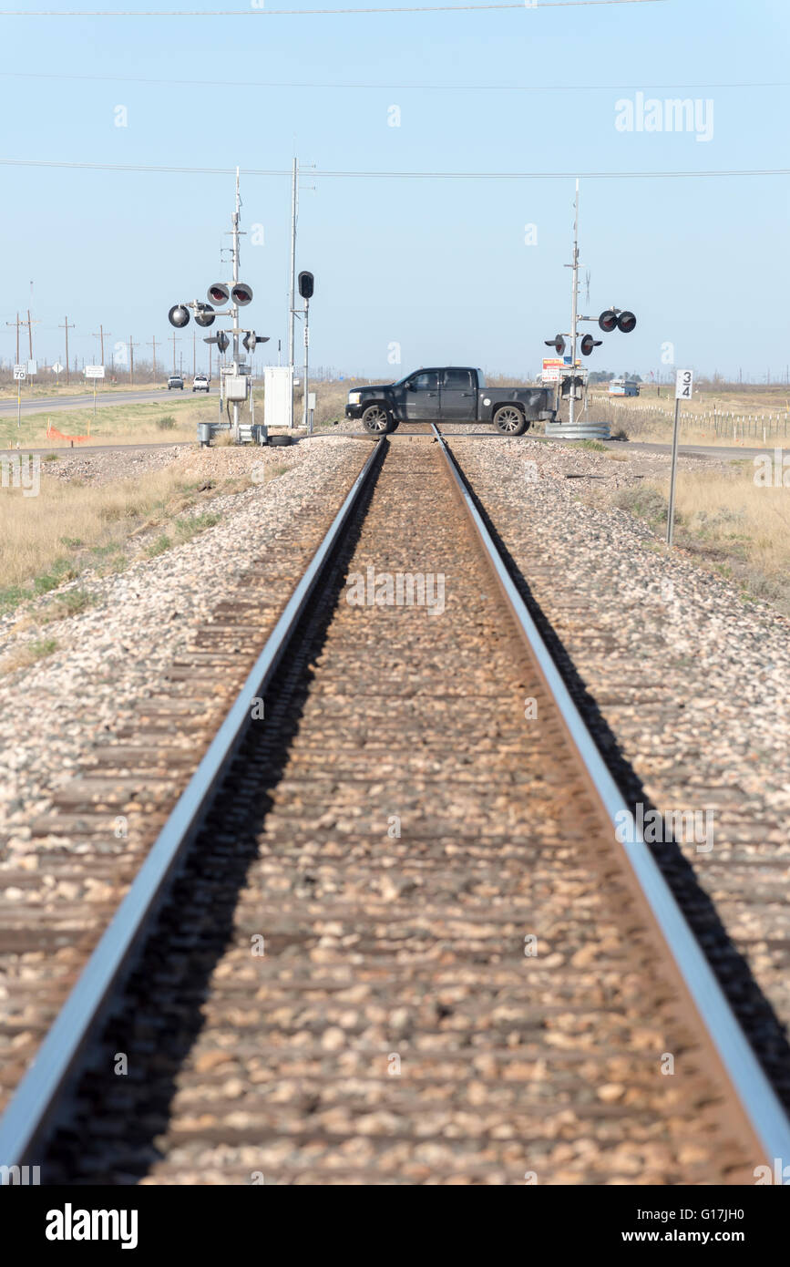 Truck crossing railroad tracks in West Texas. Stock Photo