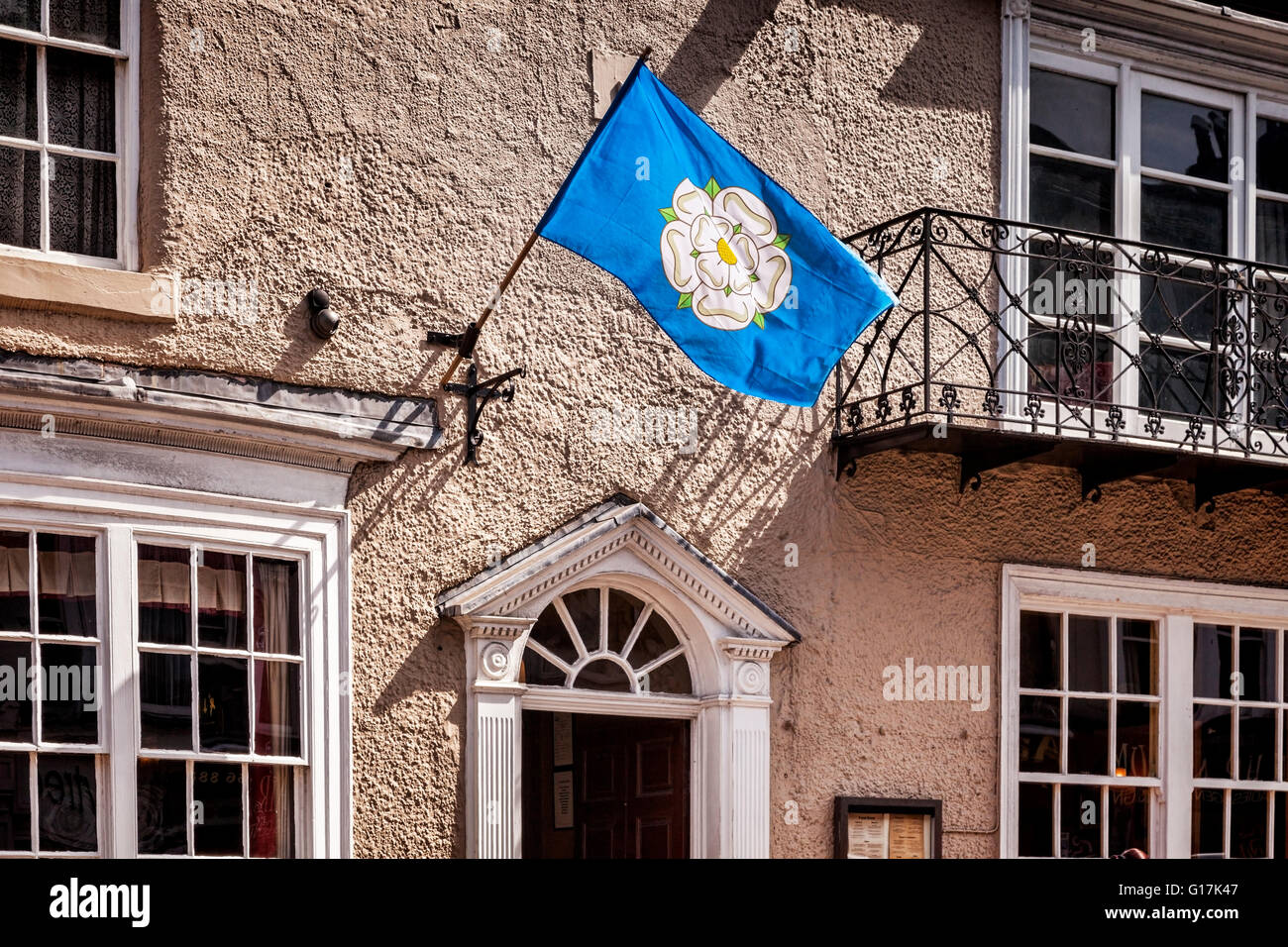 Building in the High Street in Knaresborough, North Yorkshire, flying the White Rose flag of Yorkshire, England, UK Stock Photo